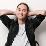 Mann mit verschränkten Armen hinter dem Kopf